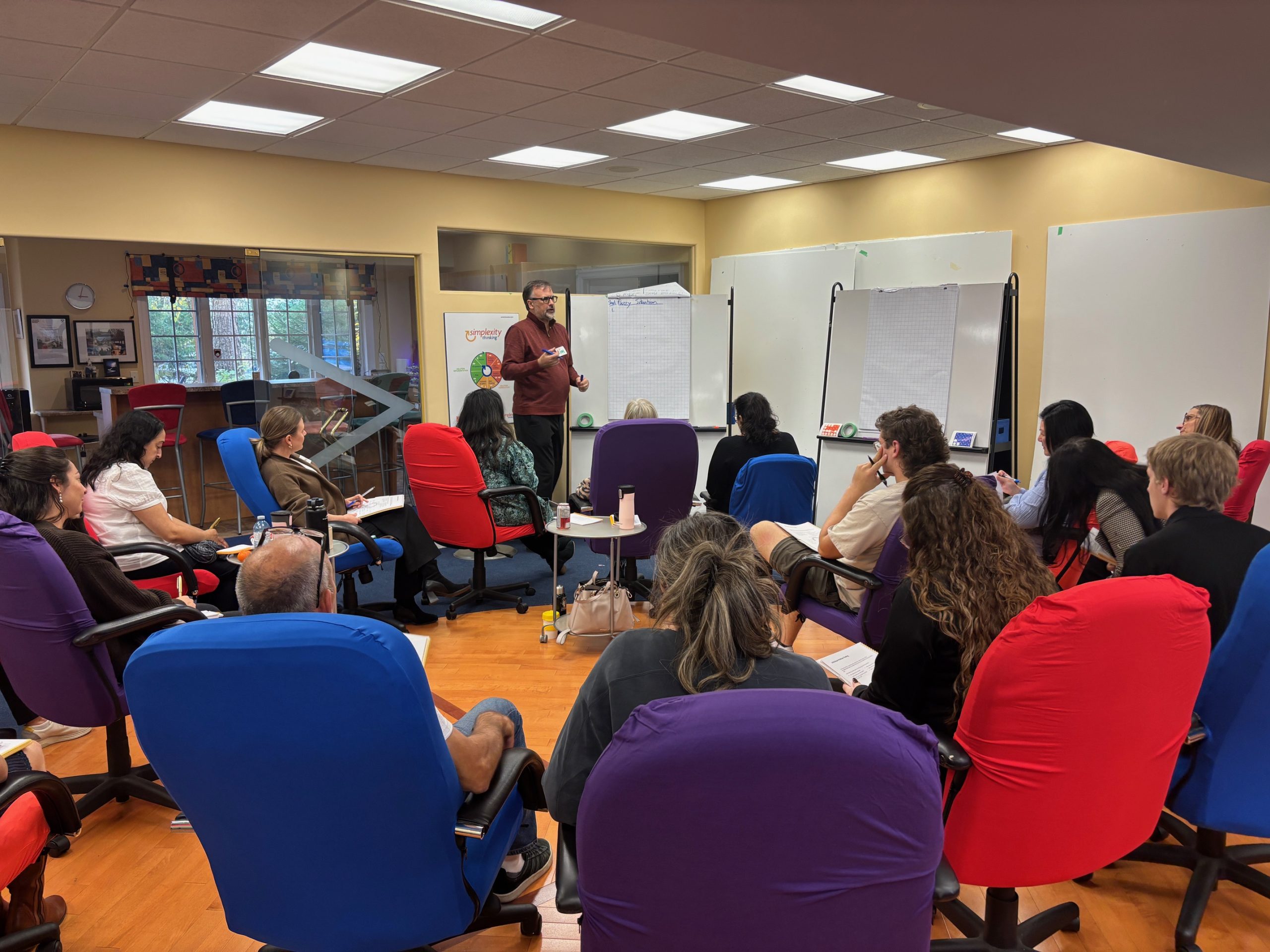 Basadur Applied Innovation Basadur team having a conversation in their office with the like minded.