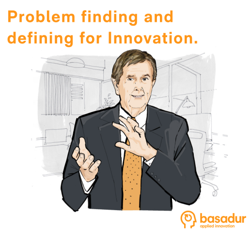 Basadur Applied Innovation logo in the bottom right corner and a caricature of Dr. Min Basadur wearing a black suit and orange tie, smiling, and holding up his hands teaching.